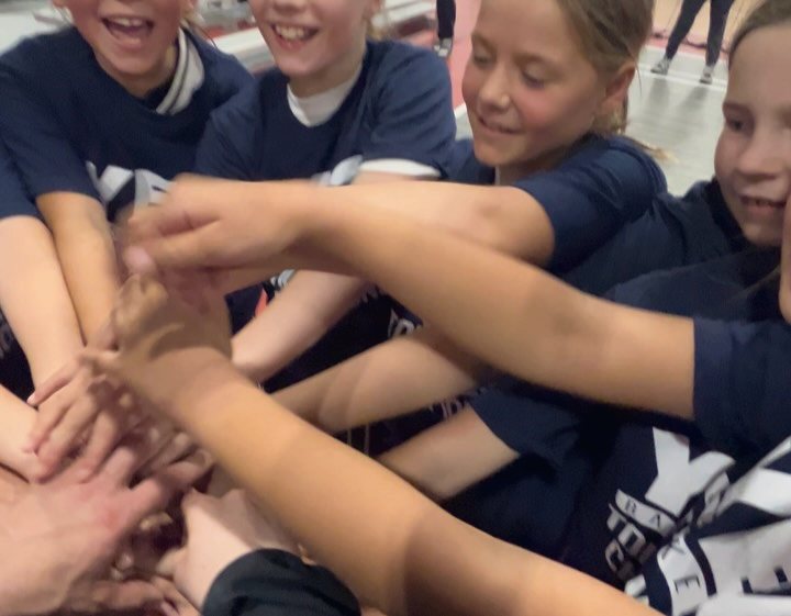 Players stacking hands in a team huddle
